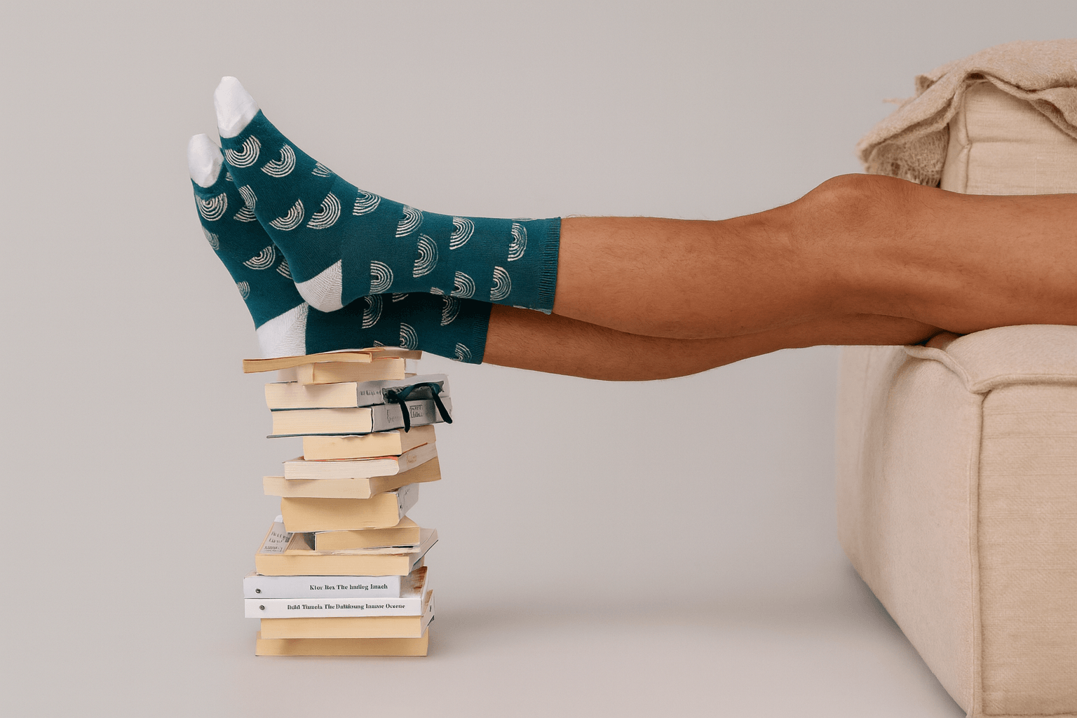 WildSock colorful socks on feet with stack of books